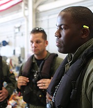 Coast Guard pilot Jason Brownlee, at right, is seen with commander John Egan, left, and flight mechanic Eric Cybulski, center. (MELISSA JELTSEN/HUFFPOST)