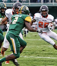 Virginia State University running back Trenton Cannon carries the ball into Norfolk State University territory during Saturday’s Labor Day Classic at Dick Price Stadium in Norfolk. Cannon finished the game with 145 yards on 26 carries, helping the Trojans to a 14-10 victory.