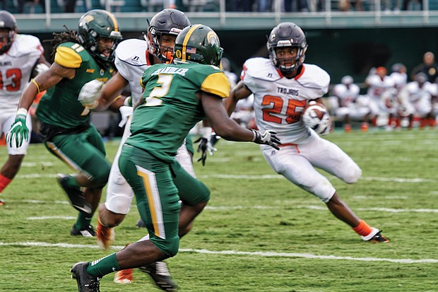 Virginia State University running back Trenton Cannon carries the ball into Norfolk State University territory during Saturday’s Labor Day Classic at Dick Price Stadium in Norfolk. Cannon finished the game with 145 yards on 26 carries, helping the Trojans to a 14-10 victory.