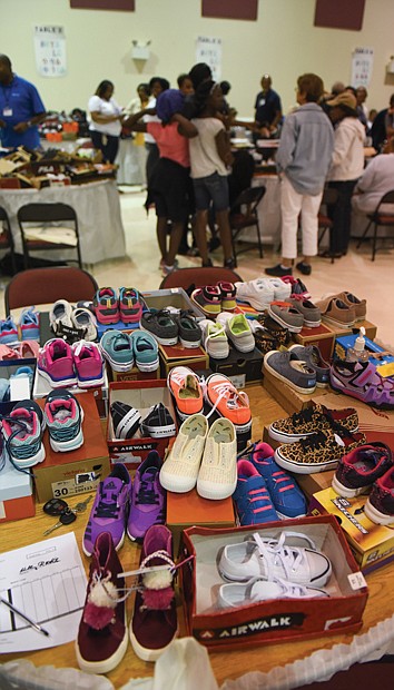 Volunteers also were on hand Monday to help youngsters make shoe selections at the program’s second location at New Deliverance Evangelistic Church Annex on Turner Road.