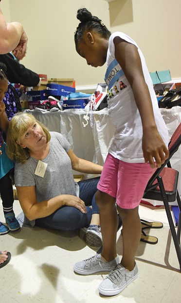 E’nyah Nash tries on a pair of sneakers,