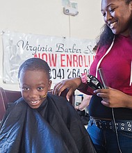 Old school party for new school year //  Antonio Daniels, 7, gets his hair cut by Zeymoria Light,
