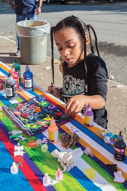 Jaliah Jackson, 4, designs her own binder pouch, at the Back-to-School Block Party held Sunday at the Richmond Association of Masonic Lodges on North 25th Street in preparation for the first day of school. 
