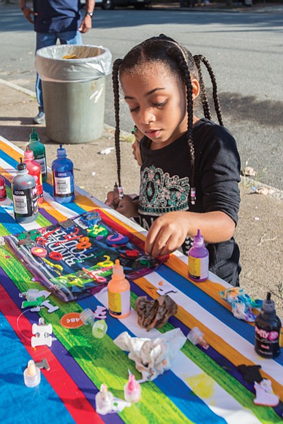 Jaliah Jackson, 4, designs her own binder pouch, at the Back-to-School Block Party held Sunday at the Richmond Association of Masonic Lodges on North 25th Street in preparation for the first day of school. 
