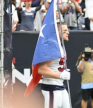 JJ Watt bringing in the Texas Flag to the Houston Texans' 2017 season opener/photo cred Semetra Samuel