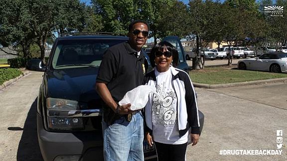 Image courtesy of Missouri City
An MCPD officer, left, accepts a disposal from a resident during a 2016 Drug Take Back Day event.