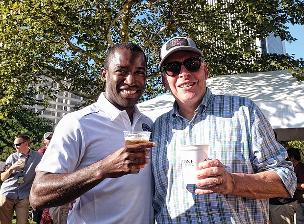 Richmond Mayor Levar M. Stoney, left, and Gov. Terry McAuliffe enjoys a drink in the sunshine during the daylong event featuring six bands.