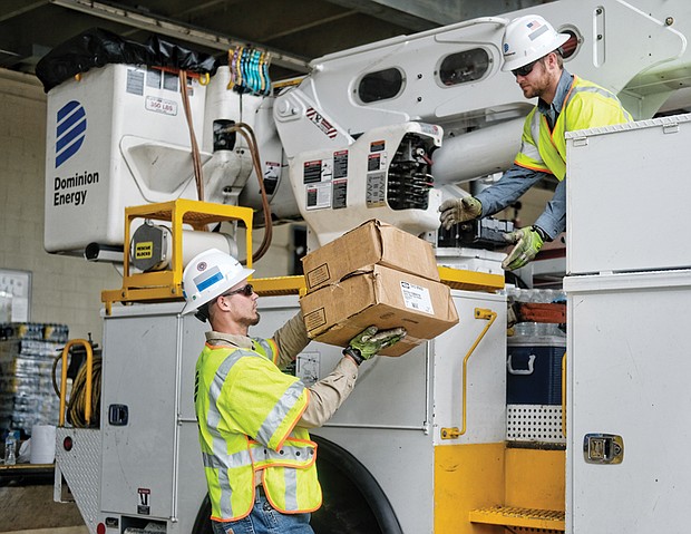 Linemen bound for Fla. to restore power lost after Hurricane Irma // Chuck Lafoon hands supplies to Justin Carmichael as the two Dominion Energy linemen load a bucket truck at the company’s operations center at 7500 W. Broad St. before heading to Florida to help restore power lost after Hurricane Irma blew through.
They are among 120 Dominion employees, including safety experts, damage assessors and others, deployed Tuesday to the Sunshine State to help rebuild the power grid from Miami to Jacksonville that the powerful storm destroyed, leaving millions of people in the dark.  
Dominion also has sent 700 employees of private tree contractors it uses in Virginia and North Carolina to help remove downed trees that took out power lines.
The company also is sending drones and helicopters to provide crews with aerial feedback about conditions they will face on the ground. 
This is just one way that Central Virginia is responding to help in the wake of hurricanes Harvey and Irma that struck Texas, Florida and several other Southern states. Everything from money to bottled water has flowed to distressed areas, while many people and rescued pets have found temporary refuge in Virginia. 
Dominion’s response is evidence of the mutual assistance pact among electric utilities that ensures outside help when a member like Florida Power & Light is overwhelmed by a storm. Florida and other states have provided similar help to Dominion after storms have knocked out power to huge swaths of the Virginia company’s grid in recent years. 
“We are proud of the willingness of our employees and contractors to leave their families and friends to work long days providing desperately needed help,” said Ed Baine, Dominion Energy’s senior vice president for power delivery.  
Mr. Carmichael said he and his colleagues expect to be away at least two weeks. He said linemen are on call 24 hours a day, seven days a week to respond to emergencies, and this is just the latest to come up. 
“We know how important our work is and how much people are depending on us at this time to get their power back on,” he said.	 
