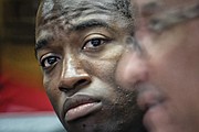 Mayor Levar M. Stoney listens intently as Police Chief Alfred Durham addresses the media about the city’s rising homicide rate at Tuesday’s news conference. 
