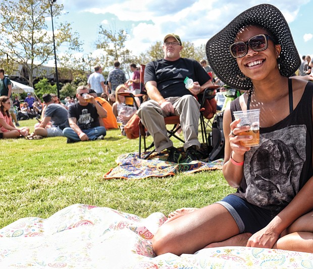 Stephanie Williams, right, enjoys a drink in the sunshine during the daylong event featuring six bands.
The City of Richmond put up more than $20 million to help attract and build the brewery in Fulton Bottom.