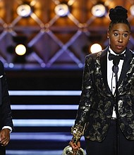Lena Waithe accepts the Emmy Award for Outstanding Writing for a Comedy Series at the 69th Primetime Emmy Awards, Sunday, September 17, 2017. She is the first African American woman to win an Emmy for comedy writing.