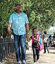 Walking my baby back home //
Harmony Otey, 5, is met by her grandfather, Jimmy Squire, or “PaPa” as she calls him, Wednesday when the last bell rang at Carver Elementary School in Richmond’s Carver neighborhood. The youngster was excited about spending the evening with PaPa.