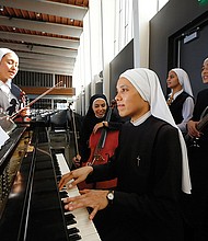  Members of Siervas, a Peruvian-based rock ‘n’ roll band composed entirely of Catholic nuns, rehearse on Sept. 7, a day ahead of their performance at the Christ Cathedral campus in Garden Grove, Calif. The sisters insist they aren’t rock stars though they’re being considered for a nomination for a Latin Grammy and their concerts draw thousands.