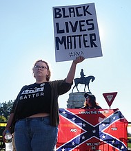 Taylor Medley offers an alternative viewpoint Saturday to neo-Confederate Tara Brandau of Florida, a co-organizer of Saturday’s rally on Monument Avenue to preserve the statue of Lee and other Confederates.