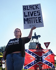 Taylor Medley offers an alternative viewpoint Saturday to neo-Confederate Tara Brandau of Florida, a co-organizer of Saturday’s rally on Monument Avenue to preserve the statue of Lee and other Confederates.