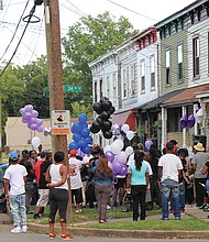 Vigil for victim of violence //
Family, friends, clergy, neighbors and co-workers gather last Friday at 34th and S streets in the East End for a candlelight vigil for Jenelle “Me Me” Smith, 26, one of three people found shot to death Sept. 10 in an apartment in Gilpin Court. The vigil, organized by Charles D. Willis of United Communities Against Crime, drew about 100 people who brought and candles in Ms. Smith’s memory. 