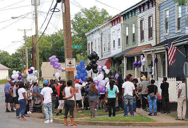 Vigil for victim of violence //
Family, friends, clergy, neighbors and co-workers gather last Friday at 34th and S streets in the East End for a candlelight vigil for Jenelle “Me Me” Smith, 26, one of three people found shot to death Sept. 10 in an apartment in Gilpin Court. The vigil, organized by Charles D. Willis of United Communities Against Crime, drew about 100 people who brought and candles in Ms. Smith’s memory. 