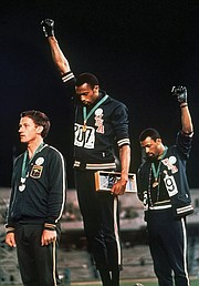 Like Mr. Smith and Mr. Carlos, Peter Norman, the silver medalist from Australia, wears a badge showing support for the Olympic Project for Human Rights.