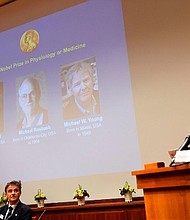 Secretary of the Nobel Committee for Physiology or Medicine Thomas Perlmann, right, announces winners.