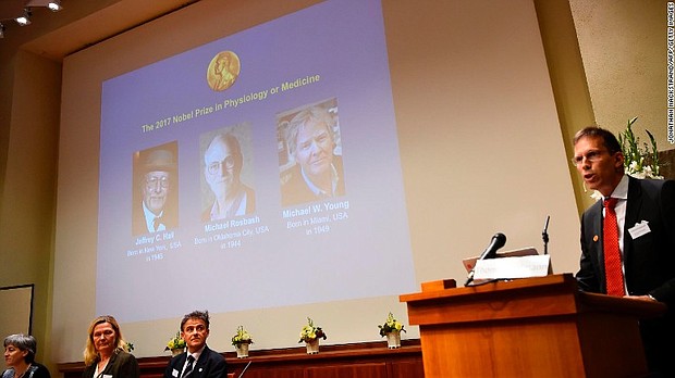 Secretary of the Nobel Committee for Physiology or Medicine Thomas Perlmann, right, announces winners.