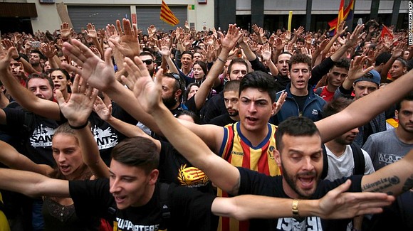 The center of Barcelona was brought to a halt Tuesday as Catalans vented their anger at the violent crackdown by …