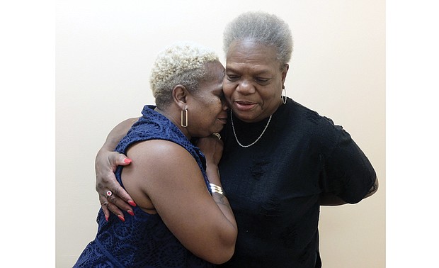 Bonnie L. Davis shares a hug with her biological mother, Sheila Dean Richardson, during an interview last week at the Free Press. They reconnected five decades after Ms. Davis was adopted shortly after her birth in Kentucky.