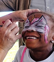 Happy face //
Six-year-old Nia McKoy grins with pleasure as Ivy MacCurtin transforms her face Saturday at the 2017 Richmond Peace Festival at St. Joseph’s Villa in Henrico County. Please see B3 for additional photo coverage. 