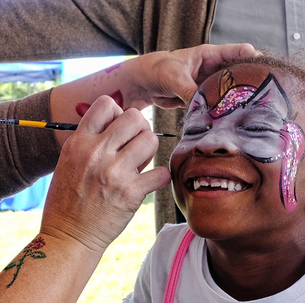 Happy face //
Six-year-old Nia McKoy grins with pleasure as Ivy MacCurtin transforms her face Saturday at the 2017 Richmond Peace Festival at St. Joseph’s Villa in Henrico County. Please see B3 for additional photo coverage. 