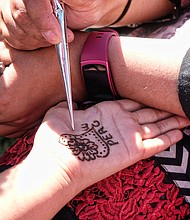 Celebrating peace and diversity //
The festival also offered henna ink tattoos, left, along with a variety of arts and crafts in seeking to carry out its mission of creating an “atmosphere of fun, fellowship and love.” First held in 2004, the festival is a cooperative effort of Bon Air United Methodist Church and the Islamic Center of Virginia. Founding sponsors include the Interfaith Council of Greater Richmond, the Richmond Peace Education Center, the Midlothian Friends, the Mormon Church the Richmond Mennonite Fellowship, the Spiritual Mind Center and the Asian-American Business Assistance Center. 