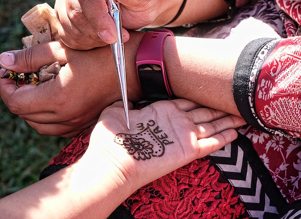 Celebrating peace and diversity //
The festival also offered henna ink tattoos, left, along with a variety of arts and crafts in seeking to carry out its mission of creating an “atmosphere of fun, fellowship and love.” First held in 2004, the festival is a cooperative effort of Bon Air United Methodist Church and the Islamic Center of Virginia. Founding sponsors include the Interfaith Council of Greater Richmond, the Richmond Peace Education Center, the Midlothian Friends, the Mormon Church the Richmond Mennonite Fellowship, the Spiritual Mind Center and the Asian-American Business Assistance Center. 