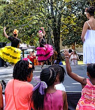 Celebrating peace and diversity // children are enthralled as members of the Latin Ballet of Virginia dance at the 14th Annual Richmond Peace Festival last Saturday at St. Joseph’s Villa. A creation of the faith community, the event celebrates peace, diversity and community and includes an interfaith service. The ballet was among an array of entertainers, ranging from rappers to African and Chinese dancers and spoken word artists. 
