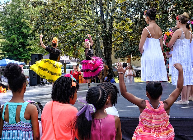 Celebrating peace and diversity // children are enthralled as members of the Latin Ballet of Virginia dance at the 14th Annual Richmond Peace Festival last Saturday at St. Joseph’s Villa. A creation of the faith community, the event celebrates peace, diversity and community and includes an interfaith service. The ballet was among an array of entertainers, ranging from rappers to African and Chinese dancers and spoken word artists. 
