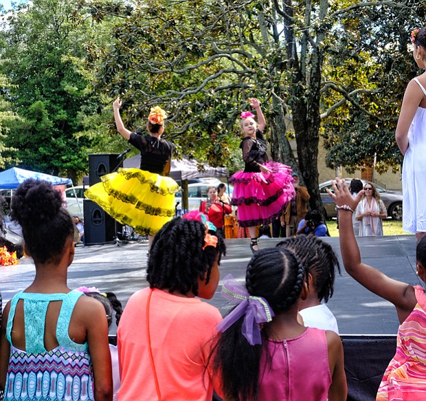 Celebrating peace and diversity // children are enthralled as members of the Latin Ballet of Virginia dance at the 14th Annual Richmond Peace Festival last Saturday at St. Joseph’s Villa. A creation of the faith community, the event celebrates peace, diversity and community and includes an interfaith service. The ballet was among an array of entertainers, ranging from rappers to African and Chinese dancers and spoken word artists. 
