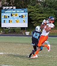 Virginia State University wide receiver Christian Harden snags the ball over the efforts of Livingstone College’s Darrel Mathis during last Saturday’s game in North Carolina. 