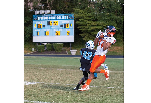 Virginia State University wide receiver Christian Harden snags the ball over the efforts of Livingstone College’s Darrel Mathis during last Saturday’s game in North Carolina. 