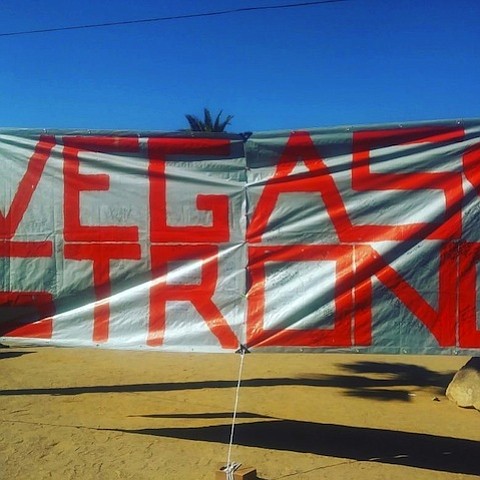 A banner with the words "Vegas Strong" is hung up near the iconic Las Vegas sign. The banner is a tribute to the victims of the Vegas concert shooting on October 1st, 2017 as well as the LVMPD.