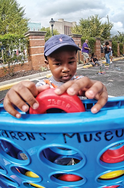 Festival fun //
Jackson Daniel plays a giant game of Connect 4 at the 2nd Street Festival in Jackson Ward last Saturday. The weekend festival showcased various musical genres, foods, local vendors and artists. Please see more photos on B3.