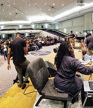 Reshada Pullen-Jireh paints a portrait of Lorna Pinckney as hundreds of friends and relatives celebrate her life Tuesday evening at St. Paul’s Baptist Church on Creighton Road. 