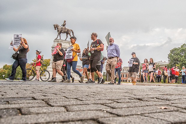 Rallying for rights //
Coalition for Accountability members gather last Tuesday near the Robert E. Lee statue on Monument Avenue and walk to Shockoe Bottom to demand the removal of Confederate statues, better schools, expanded public transportation and immigration and LGBTQ rights.