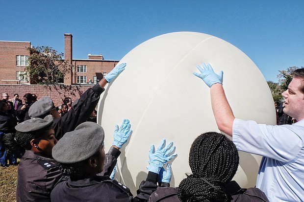 High aptitude //
Major Norman Marshall, Franklin Military School’s chemistry and computer science teacher, right, and his students work to launch a high-altitude weather balloon into the Earth’s upper atmosphere Tuesday at the East End school. The balloon is part of the team’s KnightSky project, which was started two years ago.