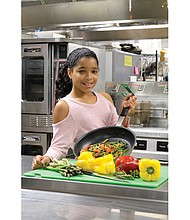 Emmy Sumpter, 11, winner of the Food Network’s Chopped Junior cooking contest, shows off her skills in the kitchen at St. Catherine’s School in Richmond’s West End.