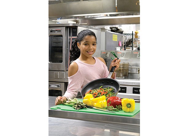 Emmy Sumpter, 11, winner of the Food Network’s Chopped Junior cooking contest, shows off her skills in the kitchen at St. Catherine’s School in Richmond’s West End.