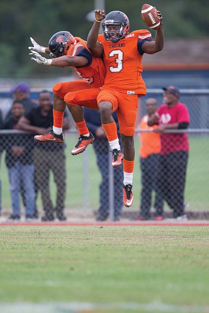 VSU celebrates homecoming //  The real action was on the field where jubilant VSU football players leap, above right, while keeping intact their winning streak. The Trojans beat Bowie State 47-35 before a festive homecoming audience of more than 17,000.
