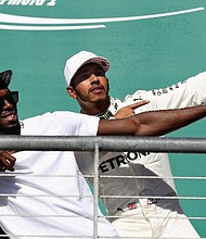 
Lewis Hamilton and Usain Bolt in familiar pose on the podium at the US Grand Prix in Austin. 
