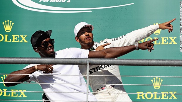 
Lewis Hamilton and Usain Bolt in familiar pose on the podium at the US Grand Prix in Austin. 
