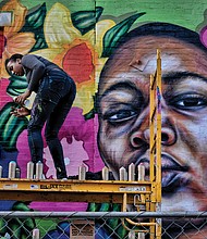 Cityscape // A colorful new mural celebrating women now decorates the 1st Street side of a Downtown building at 1st and Broad streets. Left, Austin Miles puts finishing touches on the mural last Saturday. The mural is the creation of Richmond artist Hamilton Glass in partnership with Girls For A Change, a nonprofit that seeks to inspire and support African-American girls and girls of color to achieve their dreams. 