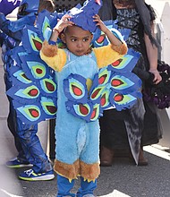 Getting in character // Aaray Kota, 3, adjusts the mask of his peacock costume, left, as he and other characters prepare for the Kids Costume Contest at the Scott’s Addition Pumpkin Festival last Saturday on the Boulevard. 
