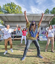 Sparking the imagination //
Dressed in colorful dashikis, the Claves Unidos dance group, above, leads an energetic crowd to join them during a performance at the Imagine Festival last Saturday at the Broad Rock Sports Complex in South Side. 