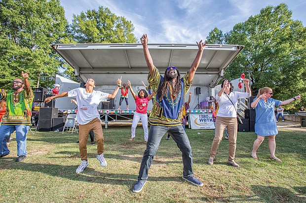 Sparking the imagination //
Dressed in colorful dashikis, the Claves Unidos dance group, above, leads an energetic crowd to join them during a performance at the Imagine Festival last Saturday at the Broad Rock Sports Complex in South Side. 