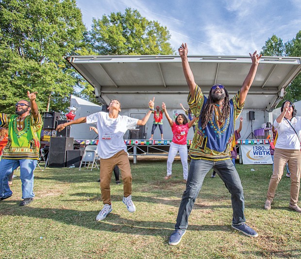 Sparking the imagination //
Dressed in colorful dashikis, the Claves Unidos dance group, above, leads an energetic crowd to join them during a performance at the Imagine Festival last Saturday at the Broad Rock Sports Complex in South Side. 